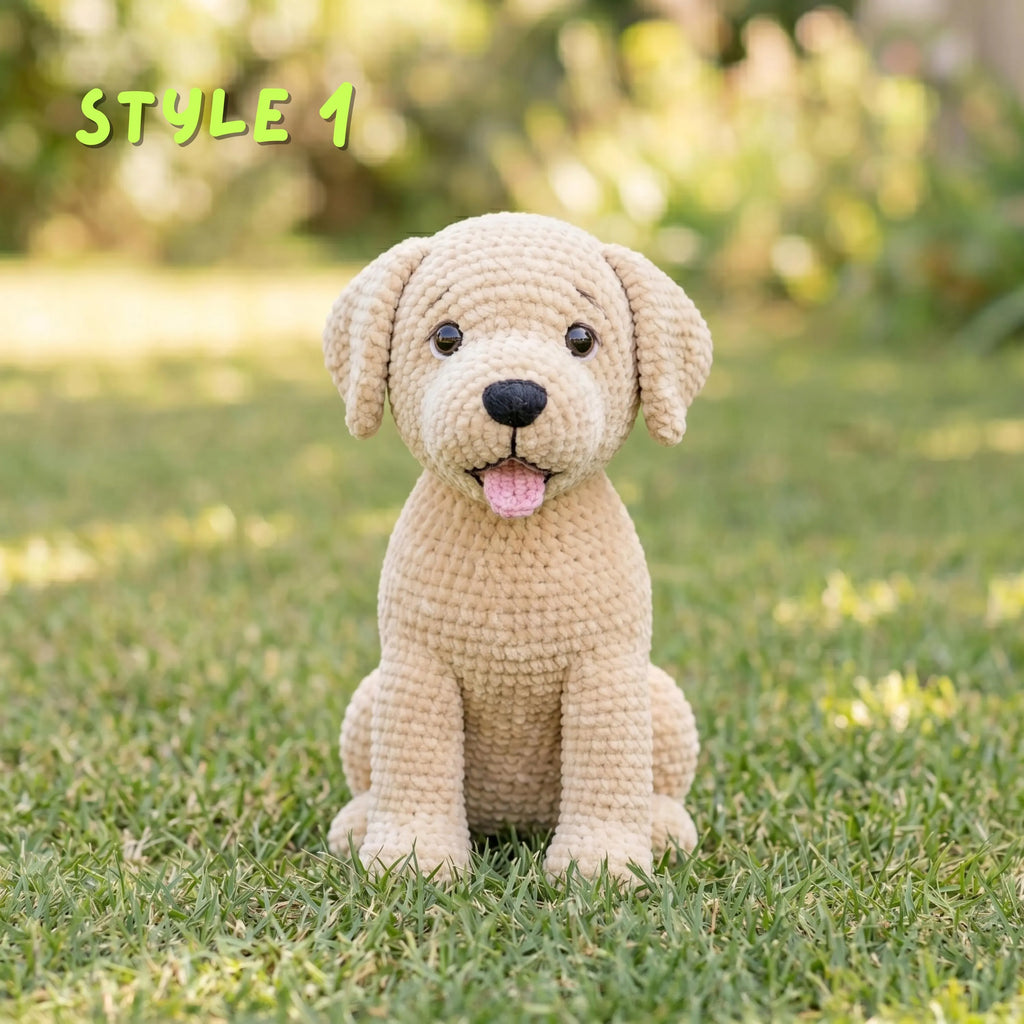 A crocheted puppy doll sits on green grass outdoors with a blurred garden background. The text 'STYLE 1' appears in the upper left corner.